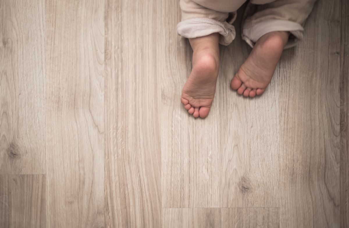 baby crawling on new floor in home remodel