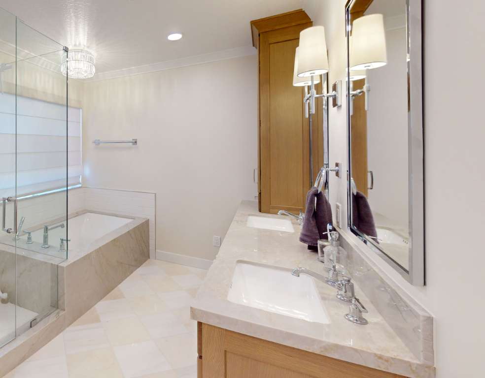 Light bathroom with matching stone counter and floor tile