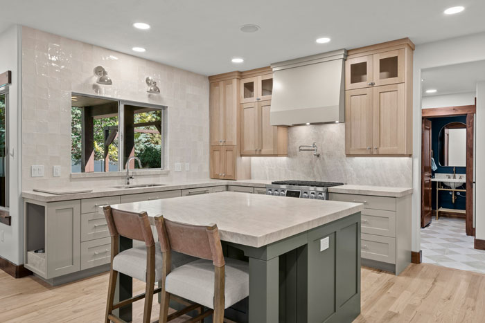 Fresh remodeled kitchen with thick stone counters and sage green island