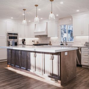 Beautiful kitchen remodel featuring two-tone cabinets, natural wood, pendant lights, part of a kitchen remodel project in Salt Lake City Utah, by Utah Home Remodel Experts